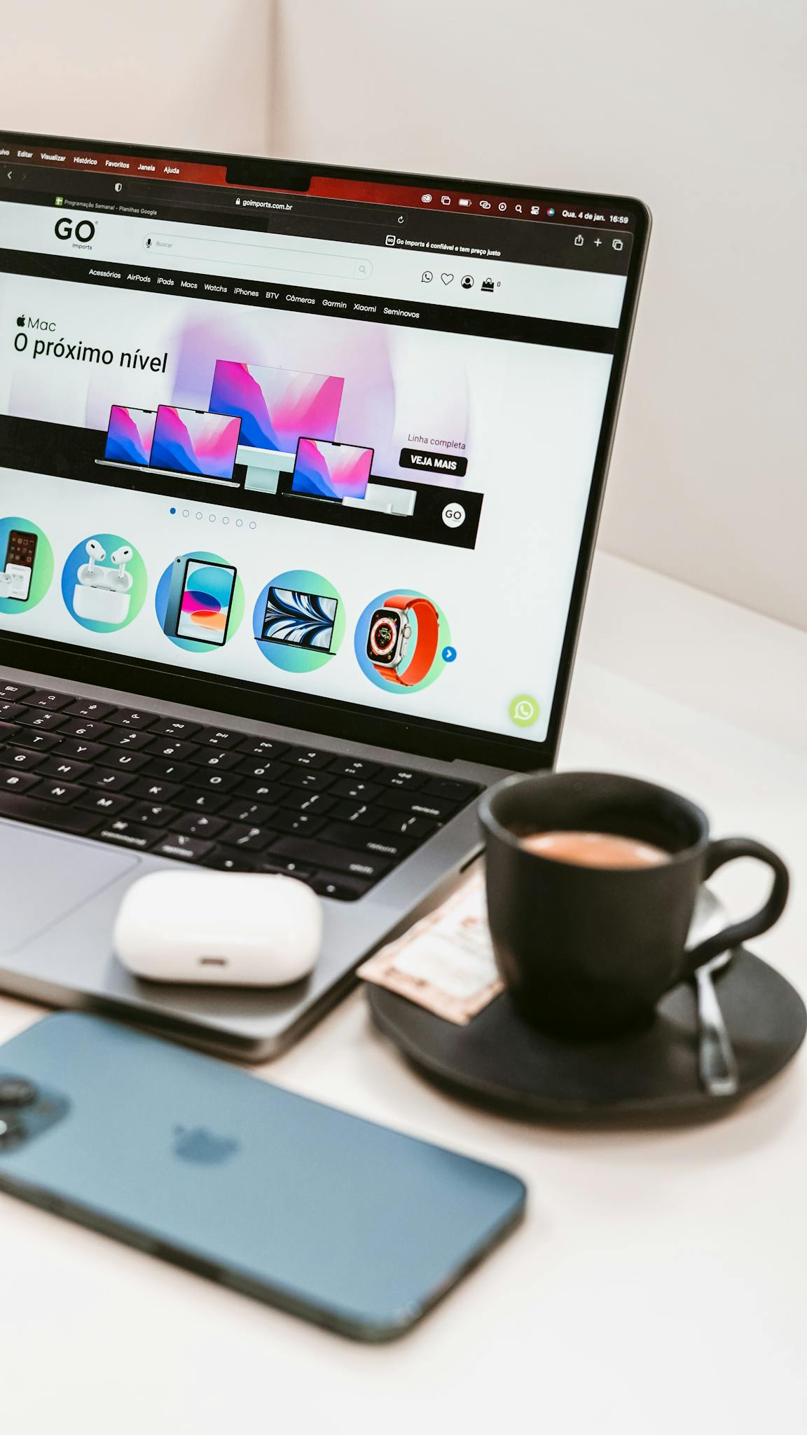 A stylish workspace featuring a laptop, smartphone, and coffee cup, embodying a modern tech lifestyle.